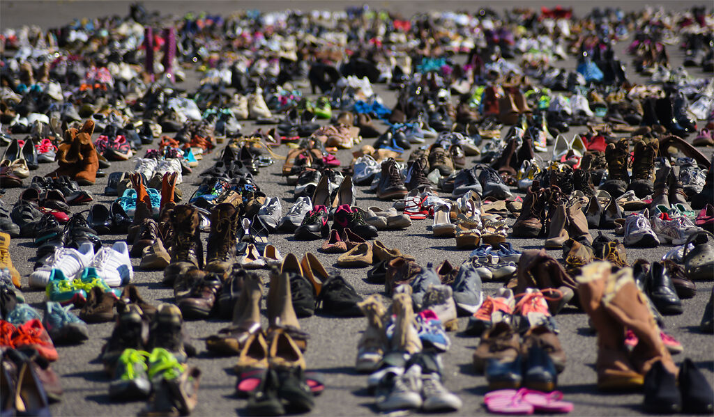 Around 1,150 pairs of shoes are displayed to represent the number of lives lost to suicide